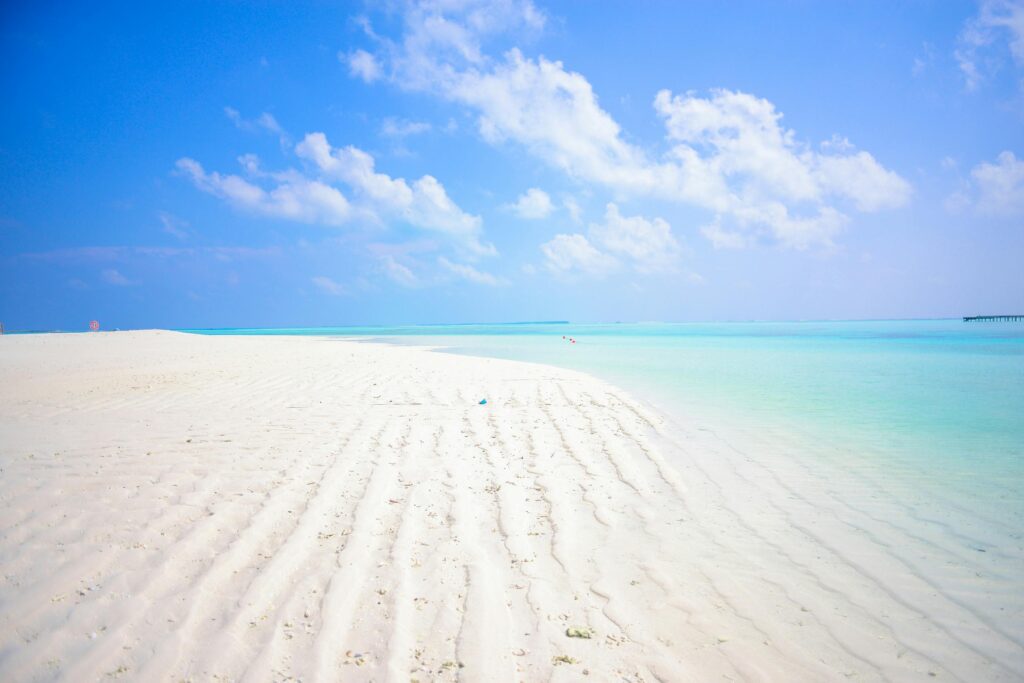 Idyllic tropical beach with white sands and turquoise sea in Maldives.