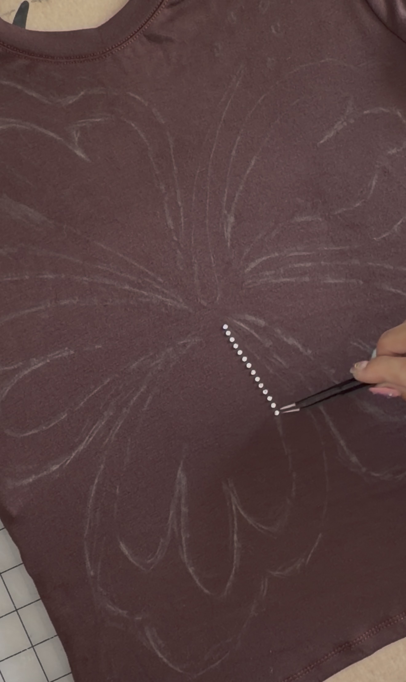 Rhinestone Baby Tee Tutorial Rhinestones being placed in a line